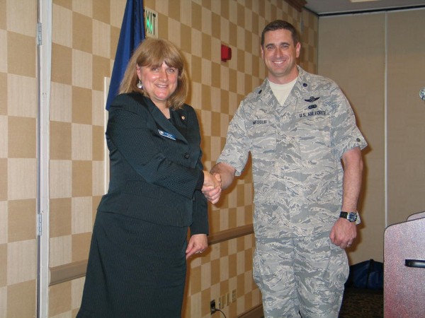 Teresa Duvall, chapter president, extends gratitude to Lt. Col. Michael G. Messer, USAF, is the senior joint fires, maneuvers, and cyberspace analyst at the Joint and Coalition Operational Analysis Directorate, Joint Staff, for his speech at the March luncheon.